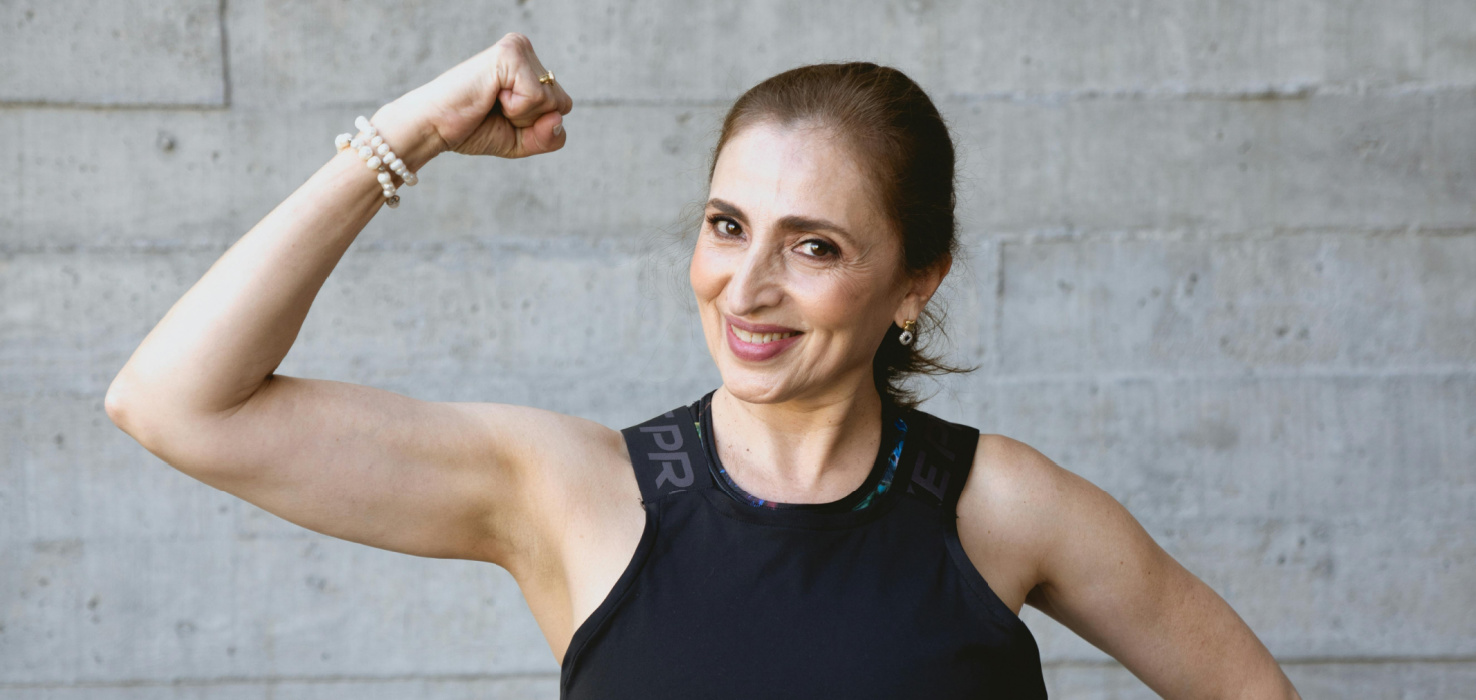 Woman flexing arm showcasing her strong muscles and bones