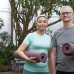couple carrying yoga mats